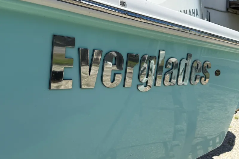 Stunning Seafoam Green Yacht Photos Pics 2022 Everglades 273 Center Console boat with chrome logo on light blue hull.
