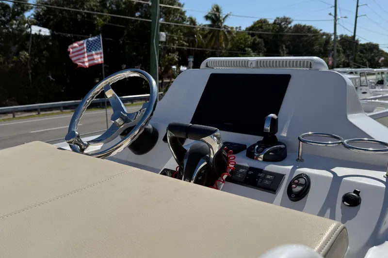 Stunning Seafoam Green Yacht Photos Pics 2022 Everglades 273 Center Console boat dashboard with steering wheel and controls.