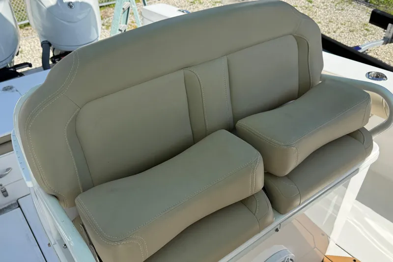 Stunning Seafoam Green Yacht Photos Pics 2022 Everglades 273 Center Console boat seat with beige upholstery and armrests.