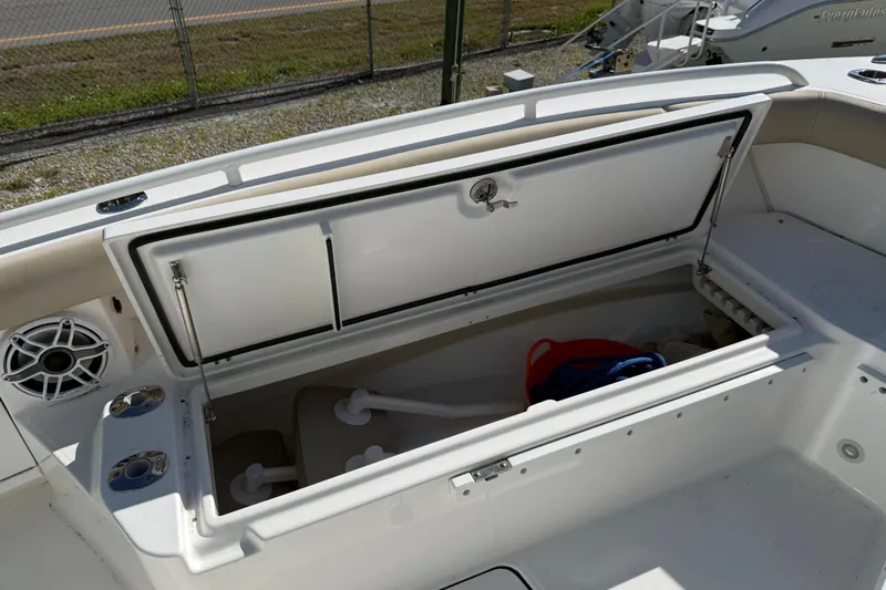 Stunning Seafoam Green Yacht Photos Pics 2022 Everglades 273 Center Console boat storage compartment open, showing interior space.