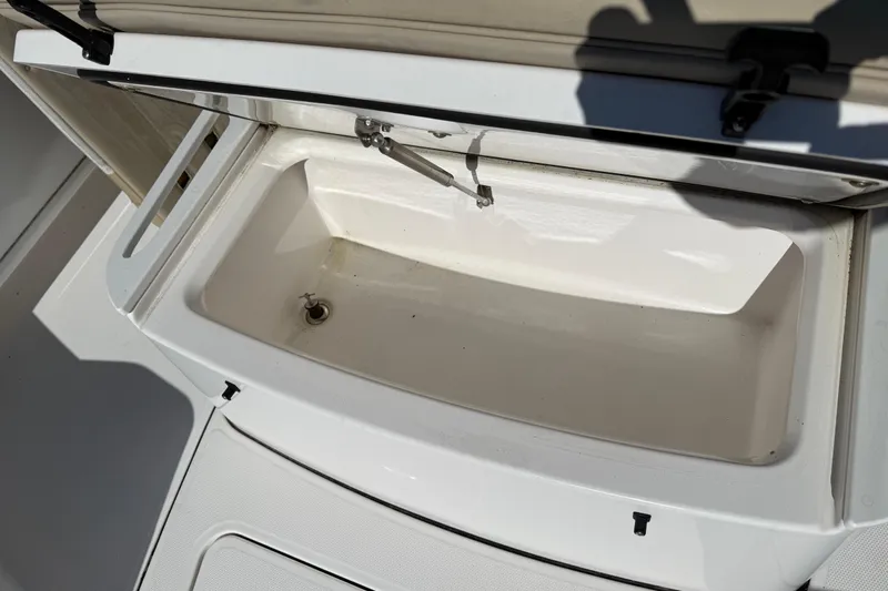 Stunning Seafoam Green Yacht Photos Pics Open storage compartment on 2022 Everglades 273 Center Console boat.