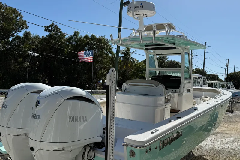 Stunning Seafoam Green Yacht Photos Pics 2022 Everglades 273 Center Console boat with dual Yamaha engines, docked outdoors.