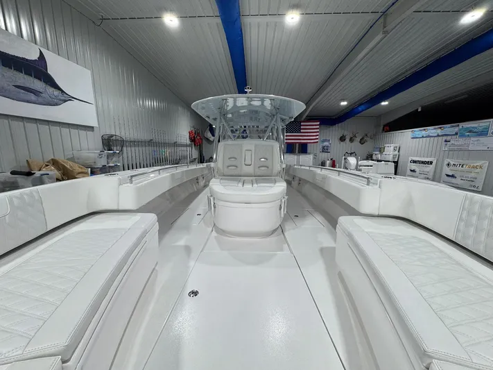  Yacht Photos Pics 2024 Contender 44 ST boat interior with white seating in a showroom.