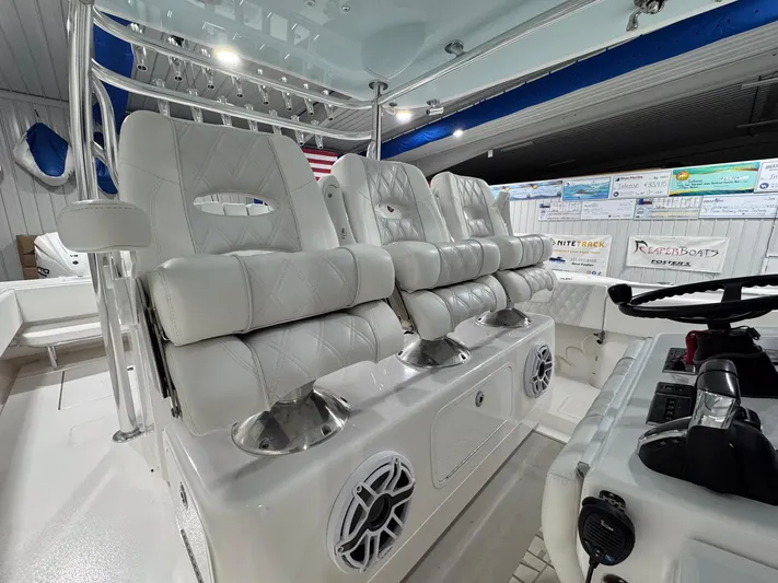  Yacht Photos Pics 2024 Contender 44 ST boat interior with luxurious white seating and modern controls.