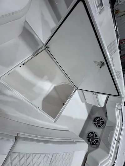  Yacht Photos Pics 2024 Contender 44 ST boat interior with open storage compartment and speaker system.