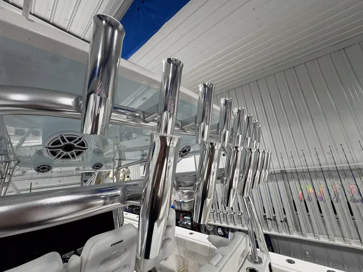  Yacht Photos Pics 2024 Contender 44 ST boat with polished rod holders and speakers in a sleek interior.