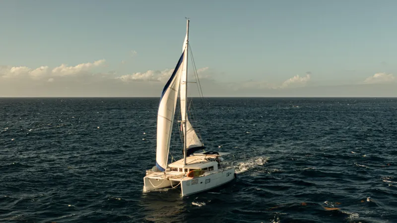 Chasing Summer Yacht Photos Pics Sailing Lagoon 400 catamaran from 2012 on open sea under clear skies.