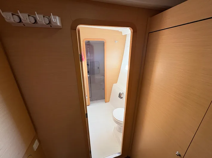 Chasing Summer Yacht Photos Pics Interior view of a 2012 Lagoon 400 yacht bathroom with wooden finish.
