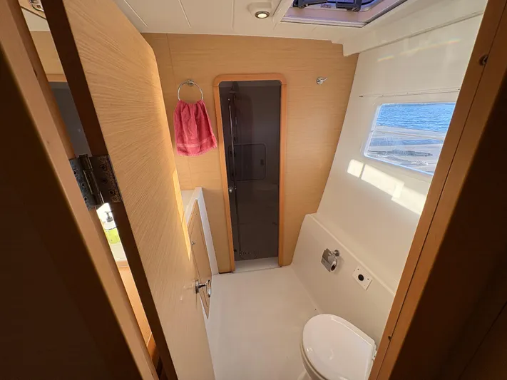 Chasing Summer Yacht Photos Pics Bathroom interior of 2012 Lagoon 400 yacht with window view and modern fixtures.
