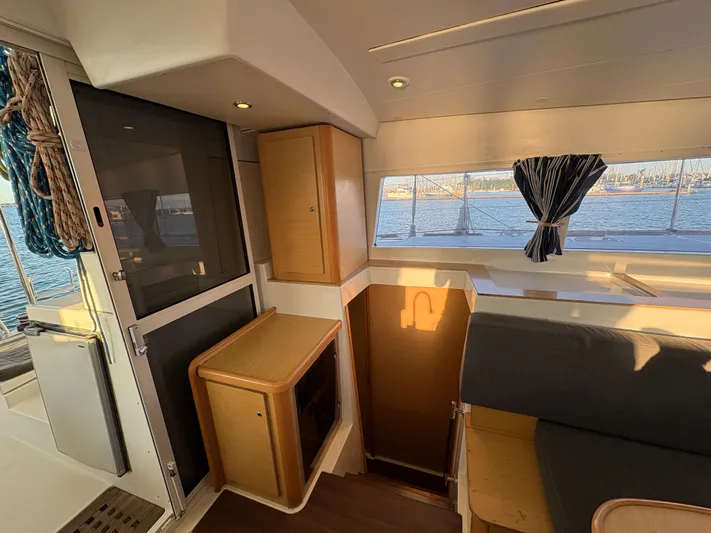 Chasing Summer Yacht Photos Pics Interior of 2012 Lagoon 400 catamaran with seating, storage, and window view.