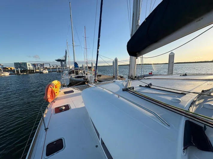 Chasing Summer Yacht Photos Pics 2012 Lagoon 400 catamaran docked at marina, calm waters, clear sky, sunset lighting.