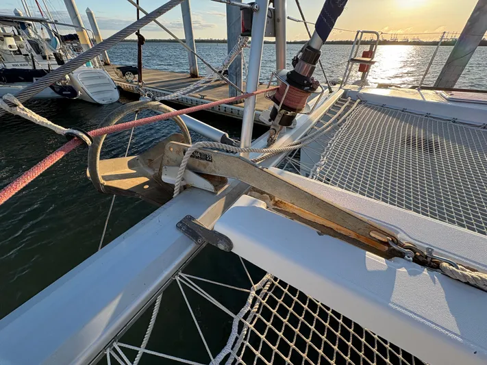 Chasing Summer Yacht Photos Pics Lagoon 400 catamaran deck with netting, docked at sunset, 2012 model.