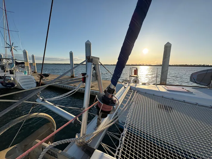 Chasing Summer Yacht Photos Pics 2012 Lagoon 400 catamaran docked at sunset, with visible rigging and netting.
