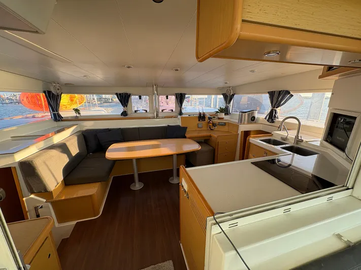 Chasing Summer Yacht Photos Pics Interior of 2012 Lagoon 400 catamaran with modern kitchen and dining area.