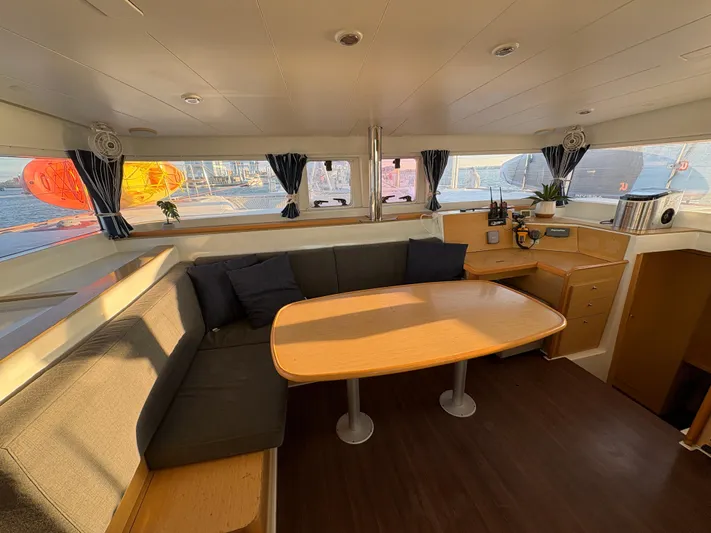Chasing Summer Yacht Photos Pics Interior of 2012 Lagoon 400 catamaran with cozy seating and dining area.