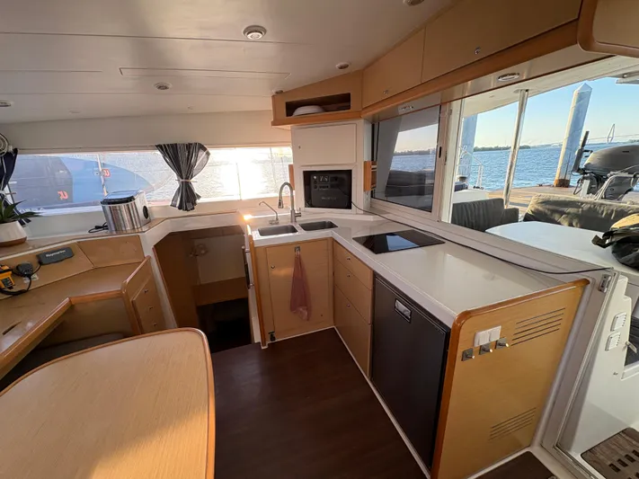 Chasing Summer Yacht Photos Pics Interior of 2012 Lagoon 400 catamaran kitchen with modern appliances and ocean view.