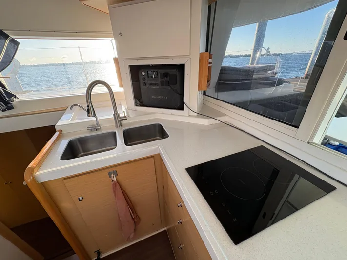 Chasing Summer Yacht Photos Pics Modern kitchen in 2012 Lagoon 400 catamaran with dual sinks and electric stove.