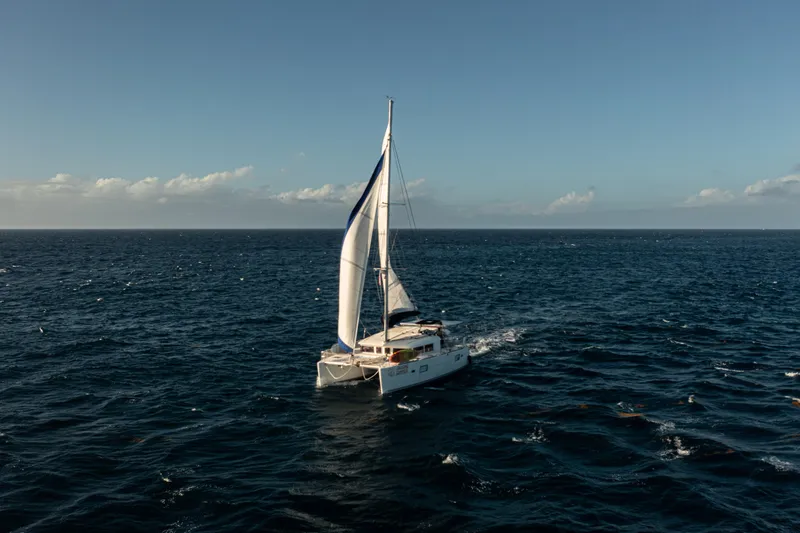 Chasing Summer Yacht Photos Pics Sailing Lagoon 400 catamaran on open sea, 2012 model, under clear blue sky.
