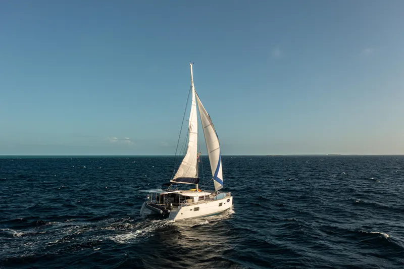 Chasing Summer Yacht Photos Pics Sailing Lagoon 400 catamaran, 2012 model, cruising on open sea under clear sky.