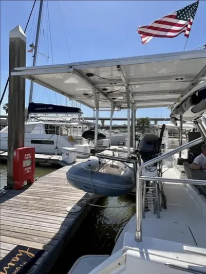 Chasing Summer Yacht Photos Pics 2012 Lagoon 400 catamaran docked, featuring an American flag and a small inflatable boat.