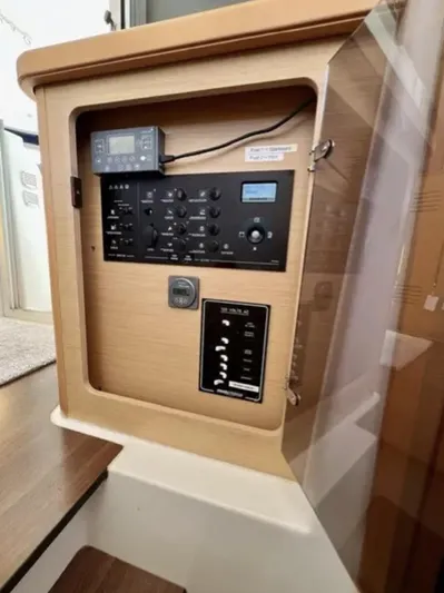 Chasing Summer Yacht Photos Pics Control panel inside a 2012 Lagoon 400 catamaran, featuring various switches and displays.