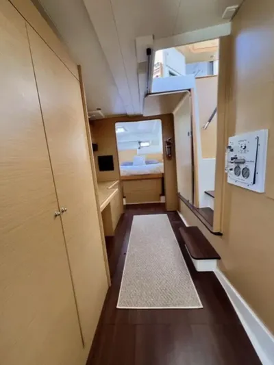 Chasing Summer Yacht Photos Pics Interior of 2012 Lagoon 400 yacht, featuring wooden cabinetry and cozy sleeping area.