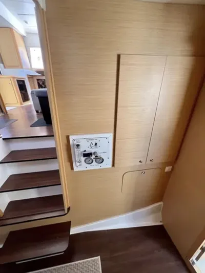 Chasing Summer Yacht Photos Pics Interior of 2012 Lagoon 400 yacht, featuring wooden paneling and staircase.