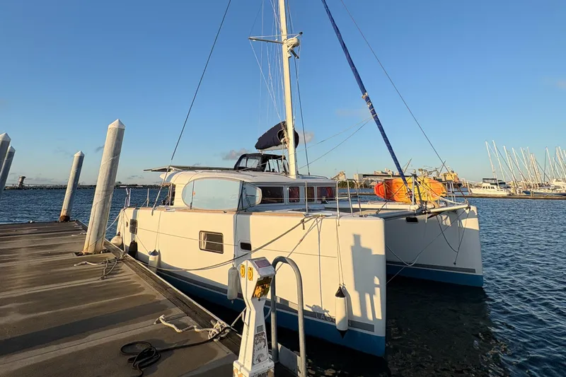 Chasing Summer Yacht Photos Pics 2012 Lagoon 400 catamaran docked at a marina under clear blue skies.