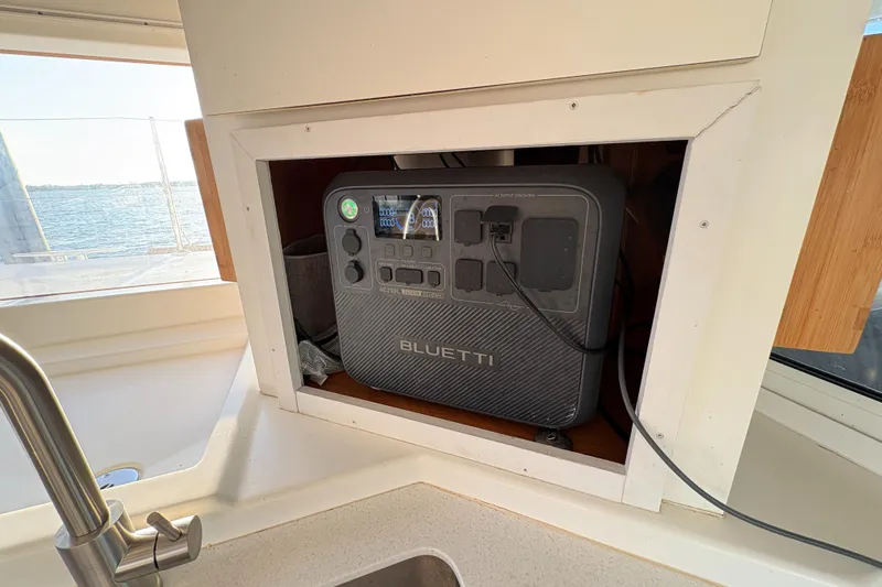 Chasing Summer Yacht Photos Pics Portable Bluetti power station in a Lagoon 400 yacht's kitchen cabinet, 2012 model.