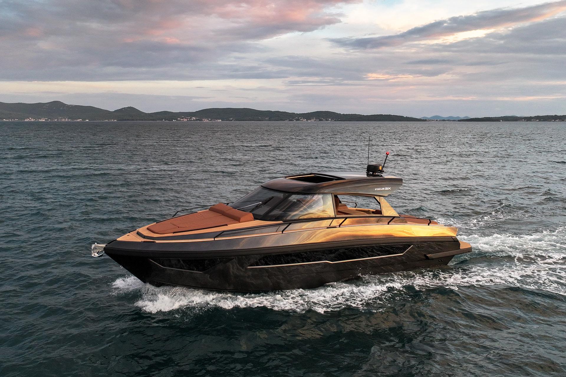 Luxurious 2025 Focus 3X yacht cruising on open water at sunset.