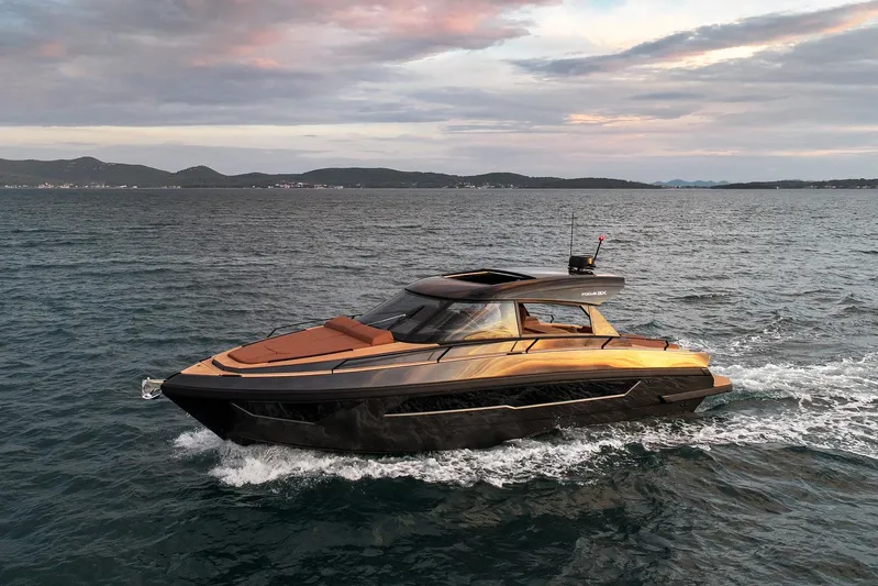  Yacht Photos Pics Luxurious 2025 Focus 3X yacht cruising on open water at sunset.
