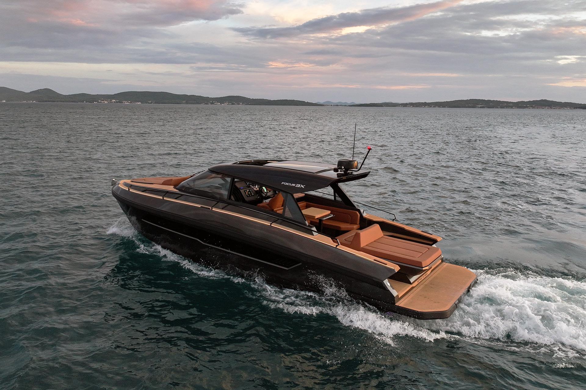 Luxurious 2025 Focus 3X yacht cruising on open water at sunset.