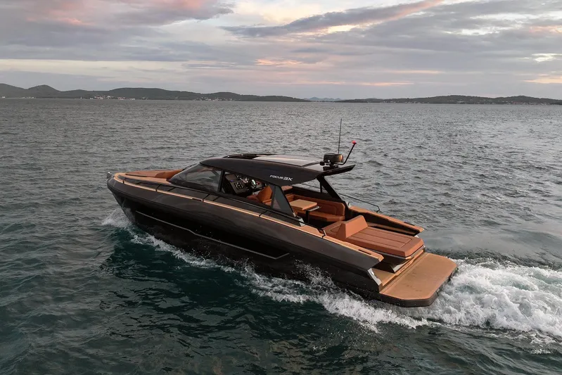  Yacht Photos Pics Luxurious 2025 Focus 3X yacht cruising on open water at sunset.