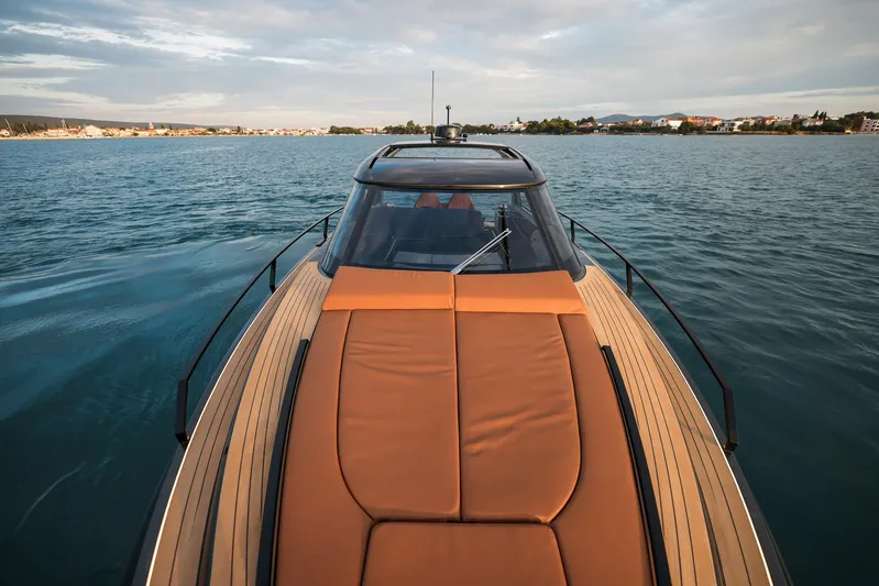  Yacht Photos Pics Luxurious Focus 3X 2025 yacht cruising on serene waters under a cloudy sky.