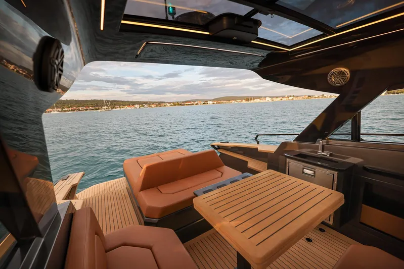  Yacht Photos Pics Luxurious 2025 Focus 3X yacht interior with elegant seating and scenic ocean view.
