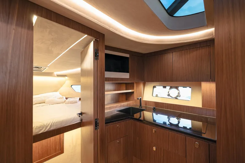  Yacht Photos Pics Luxurious interior of 2025 Focus 3X yacht with modern kitchen and cozy bedroom.