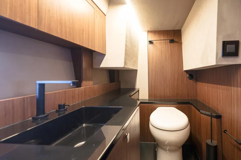  Yacht Photos Pics Modern bathroom interior in 2025 Focus 3X, featuring sleek wood paneling and black fixtures.