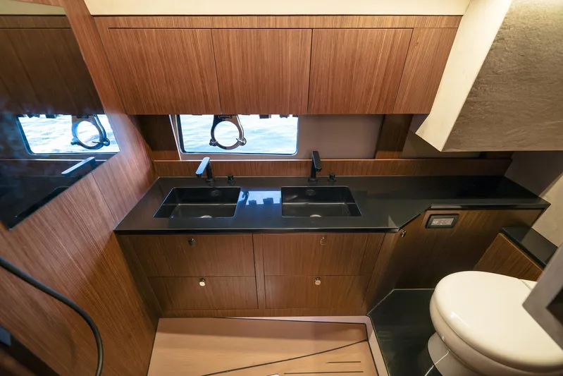  Yacht Photos Pics Luxurious bathroom interior in 2025 Focus 3X yacht with wood cabinetry and dual sinks.