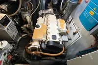 Engine room of a 2012 Amel 64 yacht, featuring mechanical components and wiring.