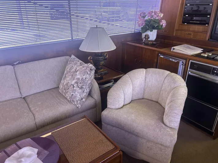 Seclusion Yacht Photos Pics Interior of 1988 Ocean Yachts 55 Super Sport with sofa, chair, and lamp.