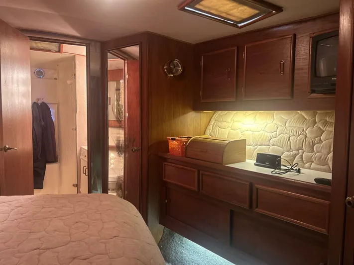 Seclusion Yacht Photos Pics Interior of 1988 Ocean Yachts 55 Super Sport with wood cabinetry and cozy lighting.