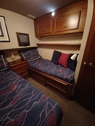 Seclusion Yacht Photos Pics 1988 Ocean Yachts 55 Super Sport cabin with twin beds, wooden cabinets, and nautical decor.