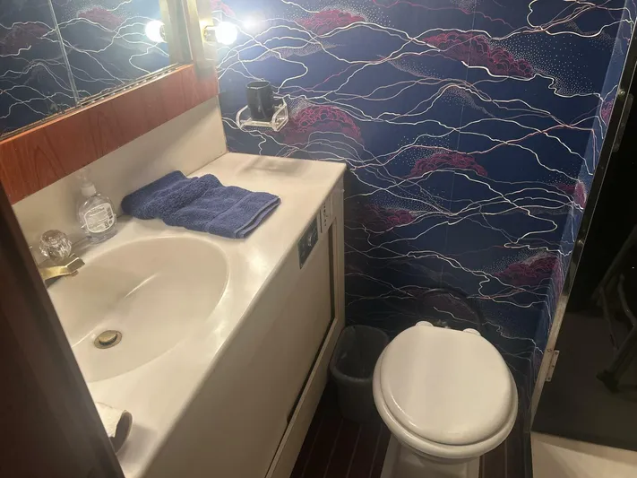 Seclusion Yacht Photos Pics Bathroom interior of 1988 Ocean Yachts 55 Super Sport with nautical-themed wallpaper.