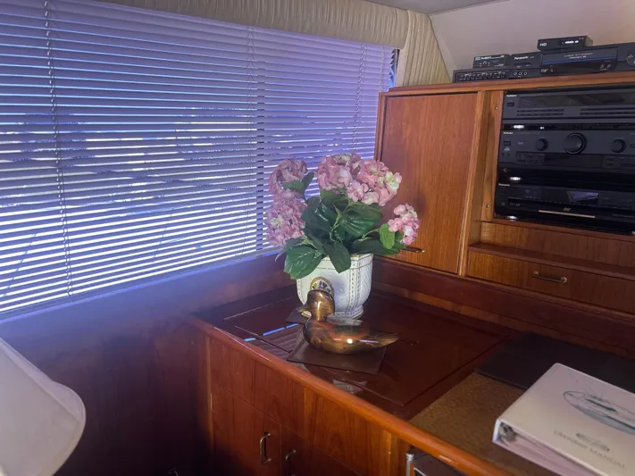 Seclusion Yacht Photos Pics Interior of 1988 Ocean Yachts 55 Super Sport with flowers and wooden cabinetry.