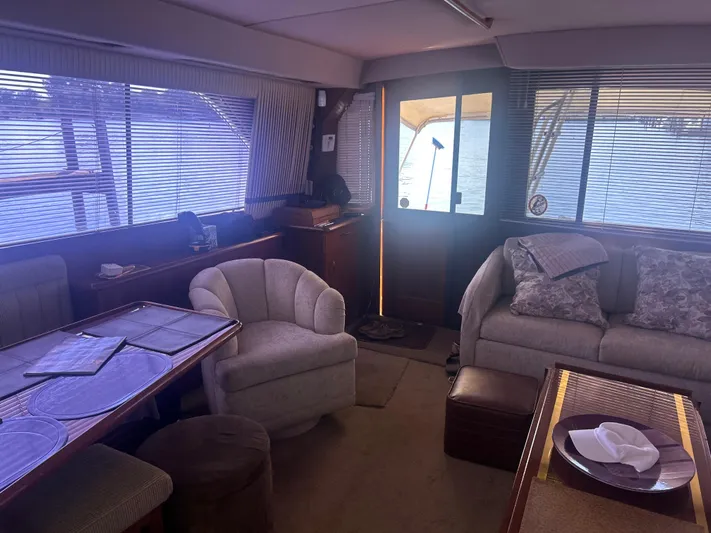 Seclusion Yacht Photos Pics Interior of 1988 Ocean Yachts 55 Super Sport with cozy seating and dining area.
