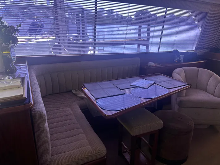 Seclusion Yacht Photos Pics Interior of 1988 Ocean Yachts 55 Super Sport with dining area and seating.