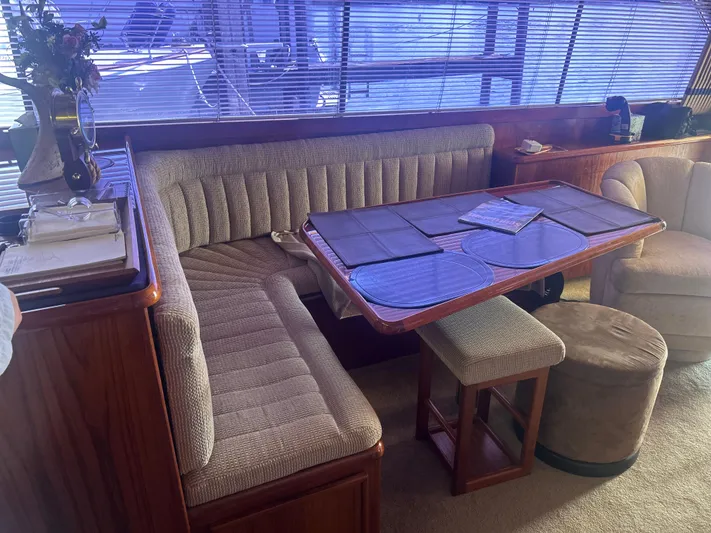 Seclusion Yacht Photos Pics Interior of 1988 Ocean Yachts 55 Super Sport with dining area and plush seating.