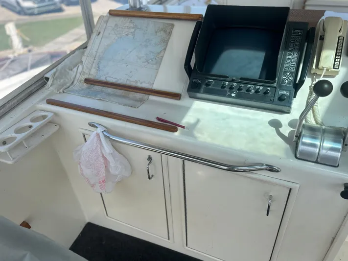 Seclusion Yacht Photos Pics Control panel of 1988 Ocean Yachts 55 Super Sport with navigation tools and equipment.