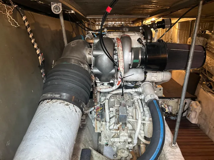 Seclusion Yacht Photos Pics Engine room of 1988 Ocean Yachts 55 Super Sport, showcasing mechanical components and piping.