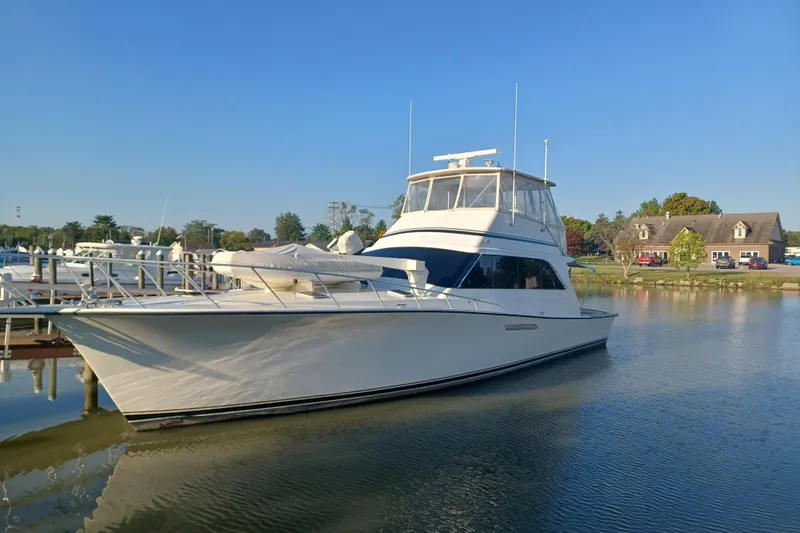Seclusion Yacht Photos Pics 1988 Ocean Yachts 55 Super Sport docked in a serene marina setting.